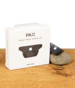 Pax Ofendeckel für halbe Befüllung auf Stein liegend neben Verpackung