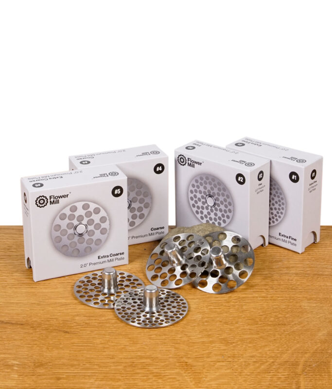 Flower Mill 2,0" Milling Plates in allen vier Varianten – Extra Fine, Fine, Coarse und Extra Coarse – nebeneinander mit Verpackung präsentiert.
