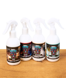 Vier Smell Crusher Absorb Sprays nebeneinander auf Holz platziert