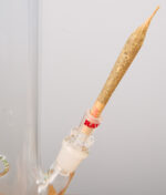 Ein fertiger Joint steckt im RAW ConeVerter Glasadapter, der als Verbindungsstück auf dem Schliff einer Glasbong sitzt.