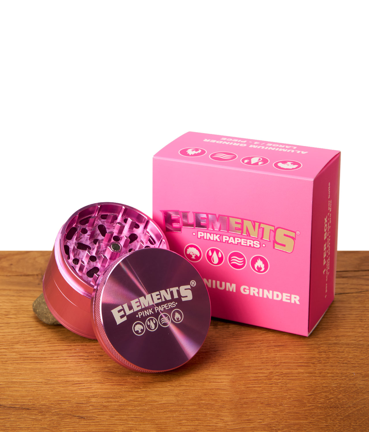 elements-pink-grinder-4-teilig-jpg Elements Pink Grinder 4-teilig aus Aluminium neben der rosa Verpackungsbox. Geöffnetes Oberteil mit Magnetverschluss.