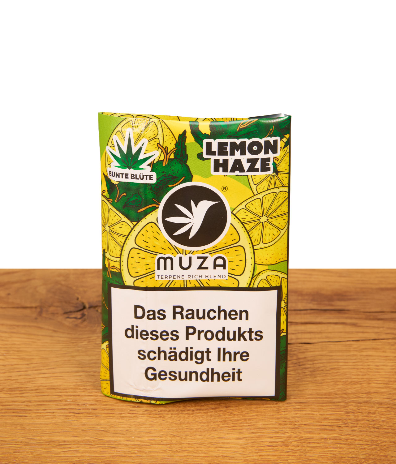 bunte-bluete-x-muza-tabak-lemon-haze-jpg Vorderseite der MUZA x Bunte Blüte Packung „Lemon Haze“ – ein nikotinfreier MUZA Tabakersatz mit Terpenen in einer gelb-grünen Tasche.