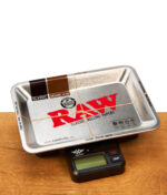 RAW Mini Metall-Tray platziert auf der schwarzen digitalen RAW Tray Scale Waage auf einem Holztisch.