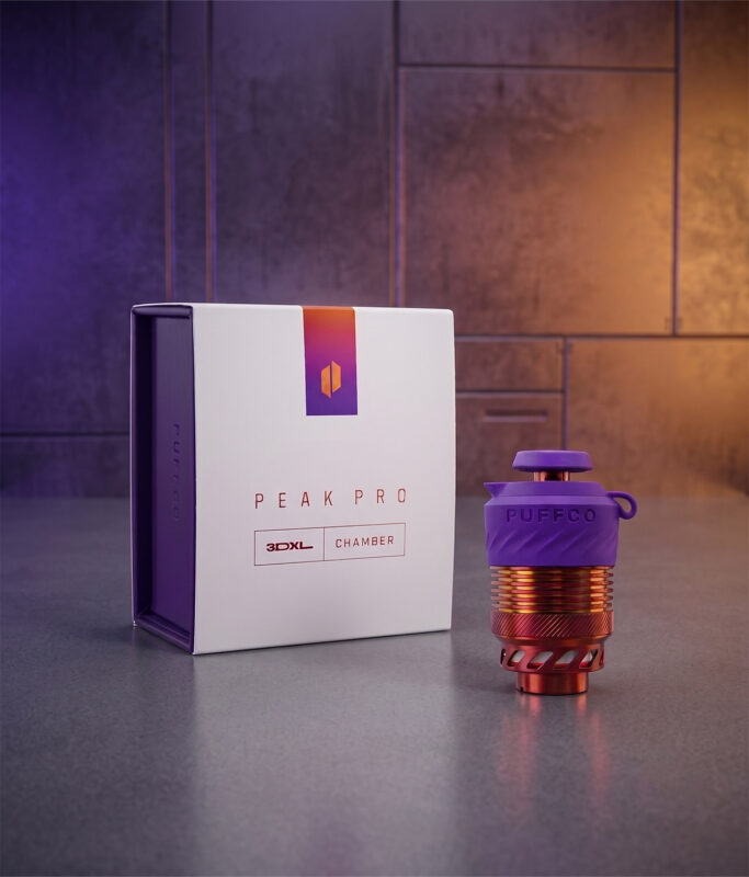 Standalone Puffco 3DXL Chamber Plasma Edition mit lila Silikonkappe neben der Produktbox auf grauem Grund.